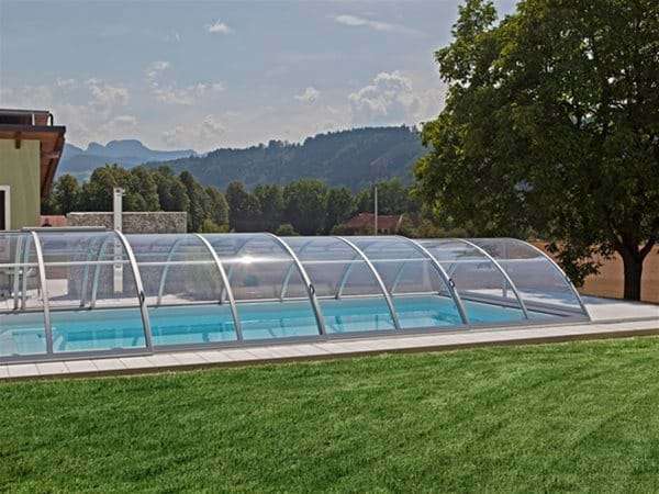 one piece swimming pool with sun or sky pool enclosure.