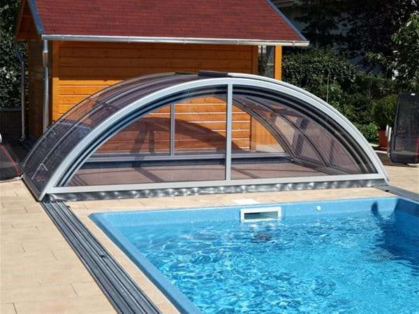 one piece swimming pool with sun or sky telescopic pool enclosure retracted.