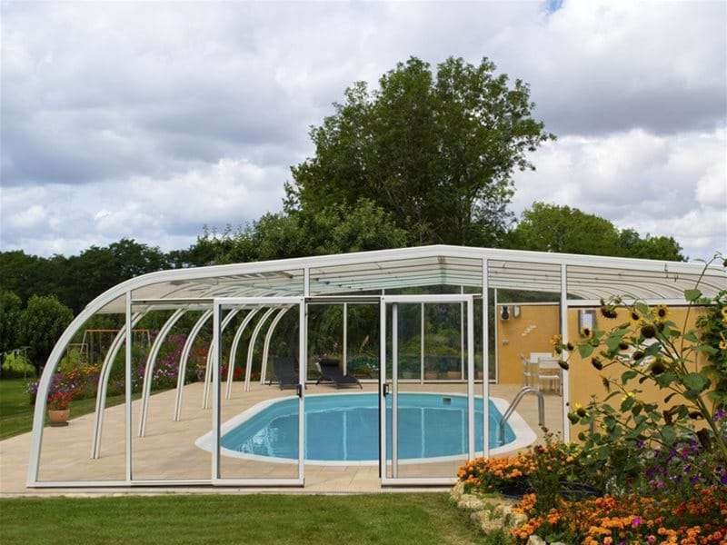 entrance view of endless summer pool enclosure covering a swimming pool.