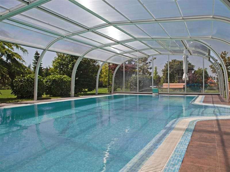 inside view of Endless Summer pool enclosure covering a swimming pool.