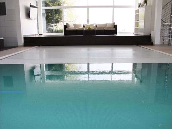 automatic slatted pool cover, half open.