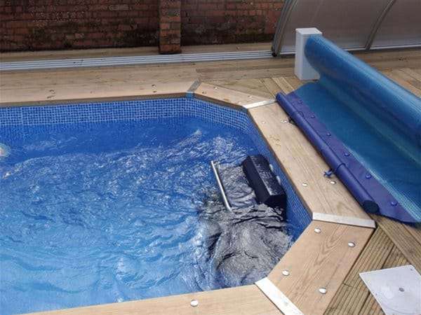 fastlane swimming machine installed at end of one piece swimming pool.