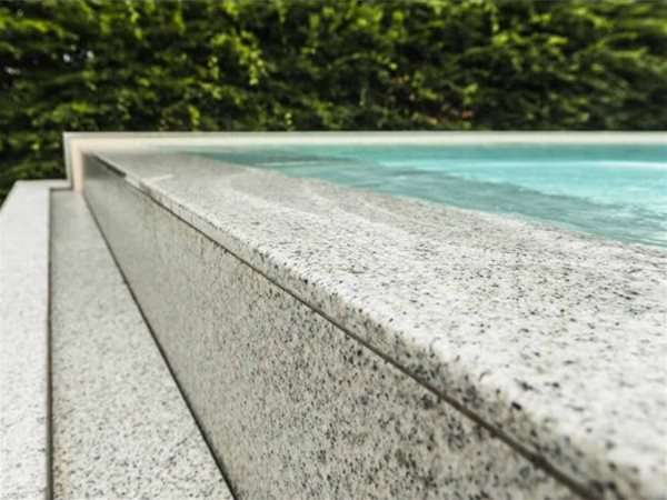 close up of overflow infinity one piece swimming pool.
