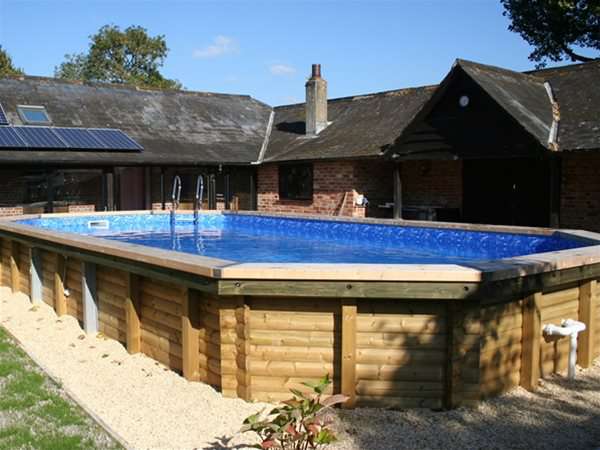 wooden pool installed as an above ground option when in-ground wasn't possible.