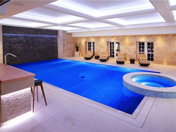 indoor pool with roldeck pool cover extended halfway.