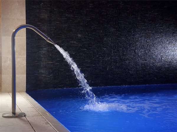Fountain from indoor pool that has a roldeck automatic pool cover installed.
