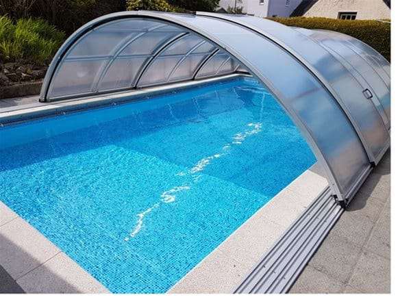 AQBox pool enclosure half open over one piece swimming pool.